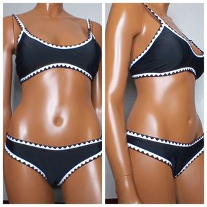 Black bikini with white pipping, NWOT, medium.